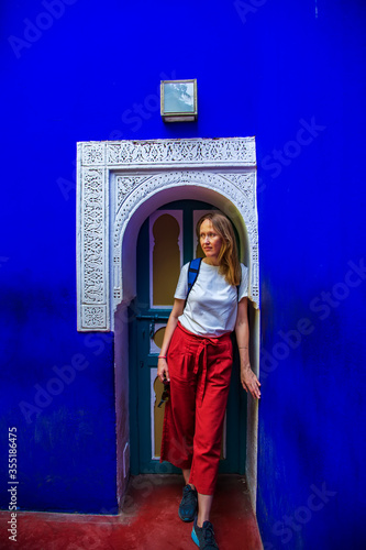 Tourist girl near the door with oriental decor.