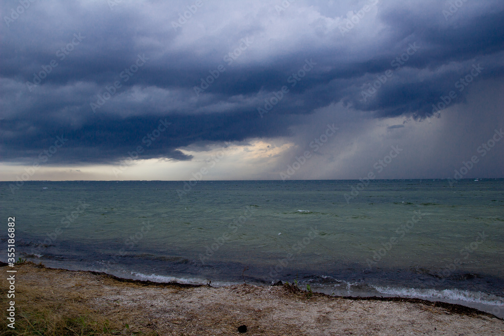 Before storm and rain on the sea. On the island. Nature. Coast of the ocean. Dark clouds. 