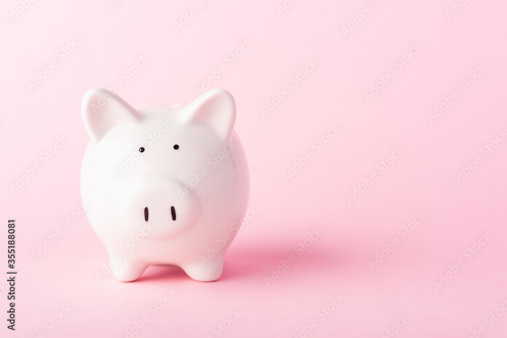 Front small white fat piggy bank, studio shot isolated on pink background and copy space for use, Finance, deposit saving money concept