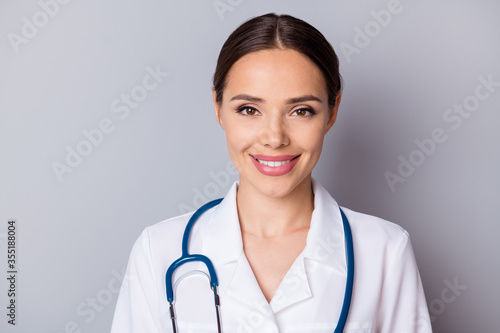 Closeup headshot photo of attractive family doc smiling experienced skilled professional listen patient good mood friendly wear medical uniform lab coat stethoscope isolated grey background