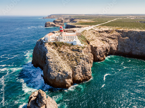 Beautiful lighthouse located on high cliffs of Saint Vincent cape in Algarve, Portugal photo