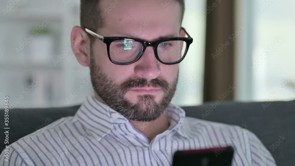Close up Serious Young Businessman using Smartphone Close up Serious Young Businessman using Smartphone