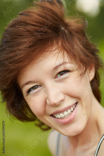 outdoor summer portrait of a happy smiling young woman.