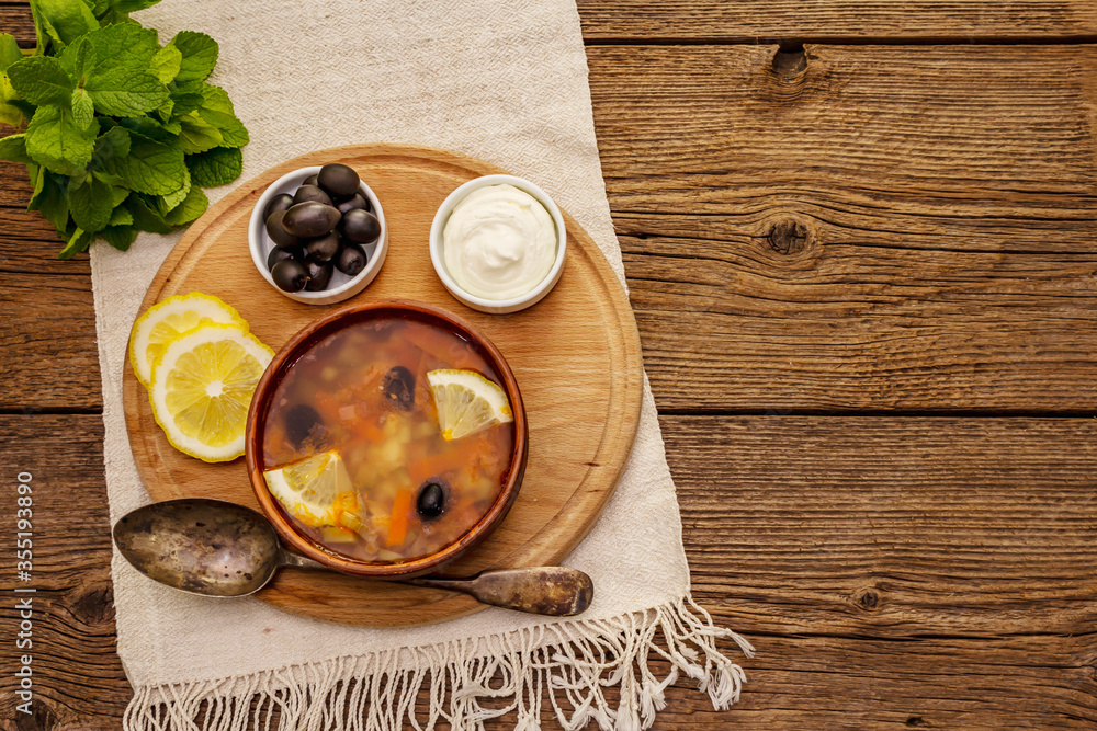 Hodgepodge, hot soup served in traditional ceramic bowl and pot. Classical Eastern Europe dish Hodgepodge, hot soup served in traditional ceramic bowl and pot. Classical Eastern Europe dish