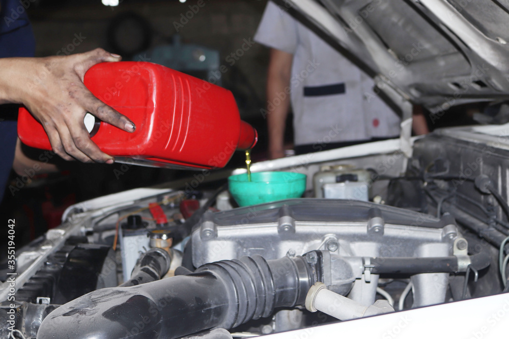 The mechanic is checking the engine. The mechanic is checking the engine.