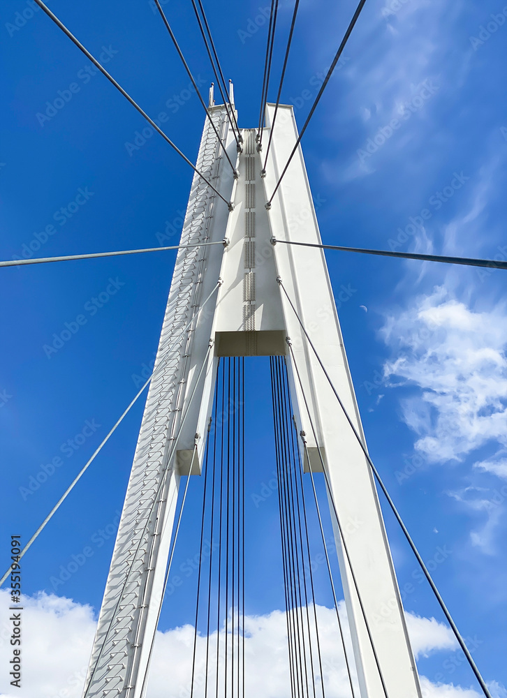 beautiful white bridge on the background of blue sky and air flying clouds view from below beautiful white bridge on the background of blue sky and air flying clouds view from below