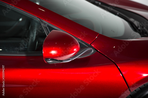 Shot of a mirror on a red sports car © camerarules