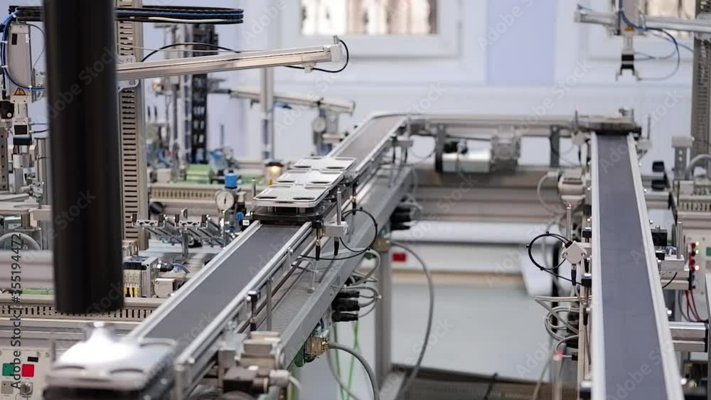 Industry 4.0 smart factory concept; artificial intelligence in production. Close-up of Gripper which picks up the product from automated car. Industry 4.0 smart factory concept; artificial intelligence in production. Close-up of Gripper which picks up the product from automated car.