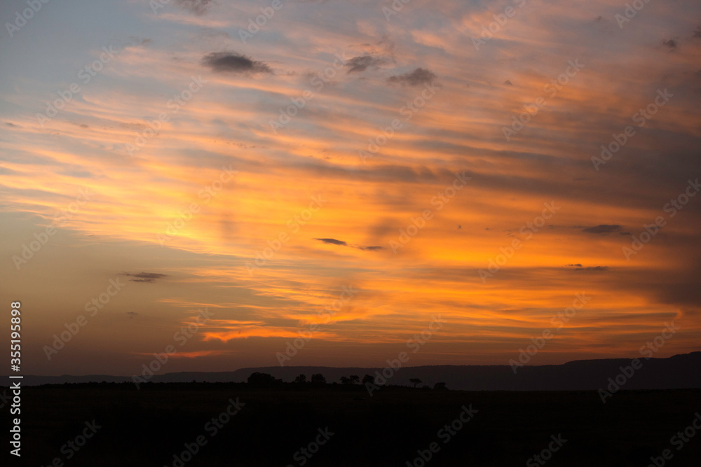 Sunset at Masai Mara with dramatic sky, Kenya