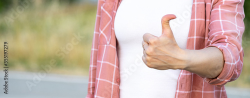 woman showing thumb up. hand with hyper flexible thumbs. Copy space photo