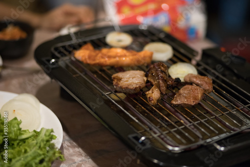 Korean BBQ. Korean BBQ Raw Beef on the Grill. grilled raw pork. Korean barbecue or yakiniku style. Beef bbq Japan. Raw beef slice for barbecue or Japanese style yakiniku