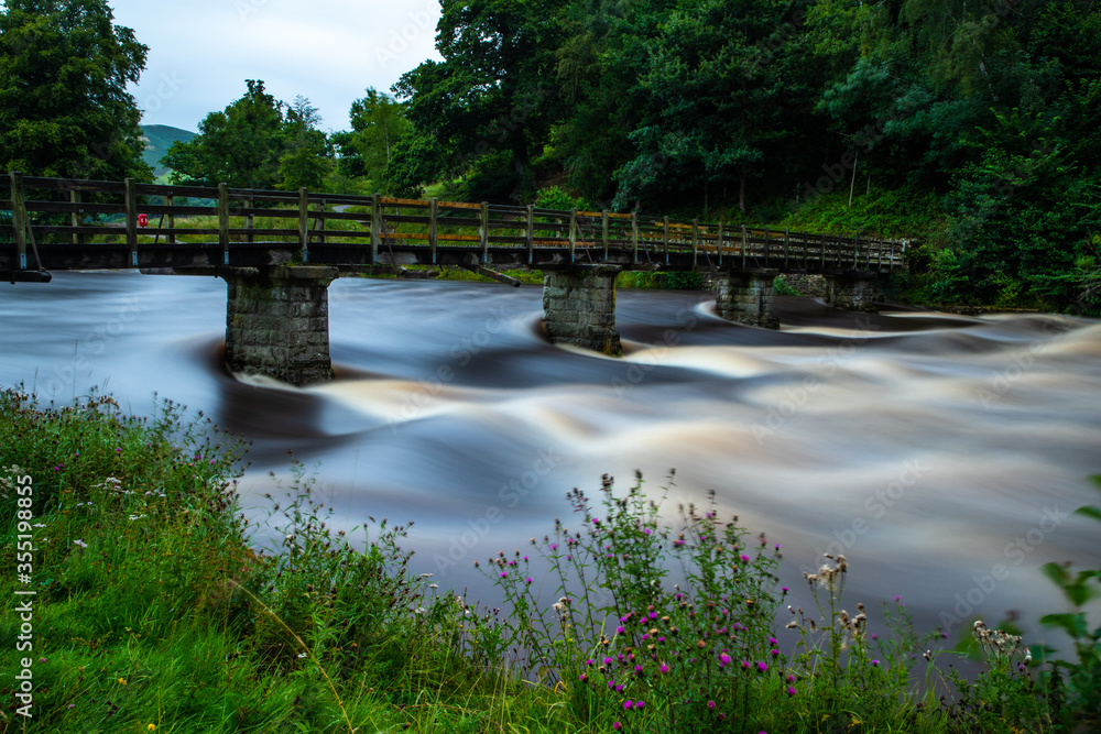 Long exposure of fast flowing river at Bolton Abbey, Yokrshire Long exposure of fast flowing river at Bolton Abbey, Yokrshire