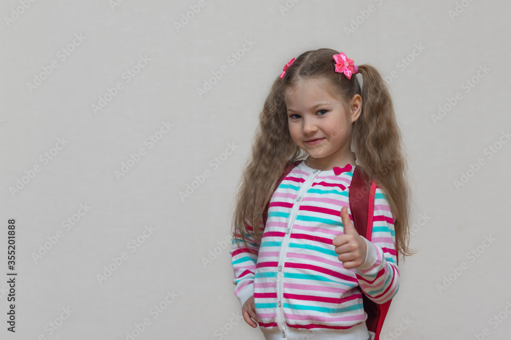 Back to school. Portrait fair-haired school girl with bag. Light grey studio background. Education. slooking and smiling at camera. copy place. Back to school. Portrait fair-haired school girl with bag. Light grey studio background. Education. slooking and smiling at camera. copy place.