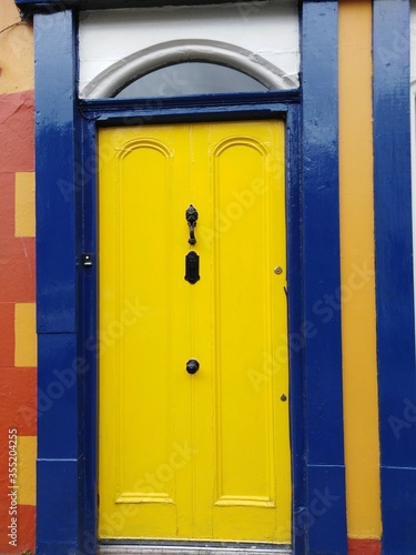 bright yellow door with yellow and blue wall