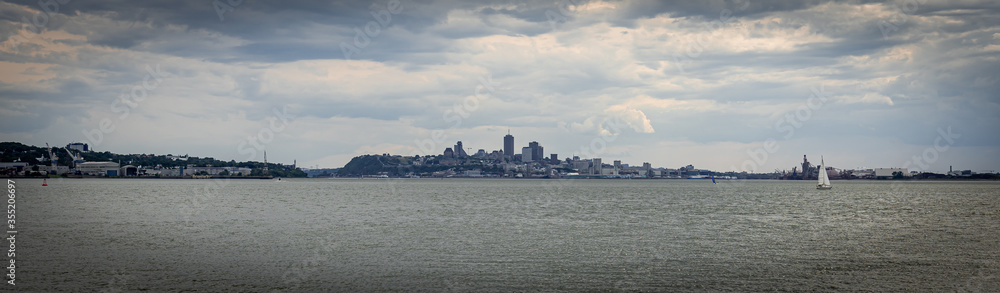 Dark banner of the city of Quebec from Orleans island in a cloudy afternoon
