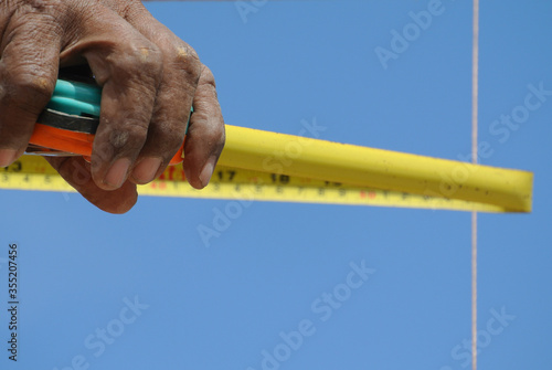 JASIN, MALAYSIA -MARCH 10, 2016: Measuring tape used at the construction site.  photo