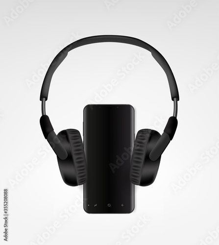 Black modern wireless headphones and black smartphone