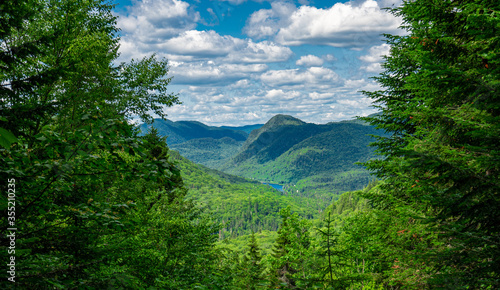 Awesome summer view from a verdant hill in Jacques Cartier National Park, Quebec province, Canada