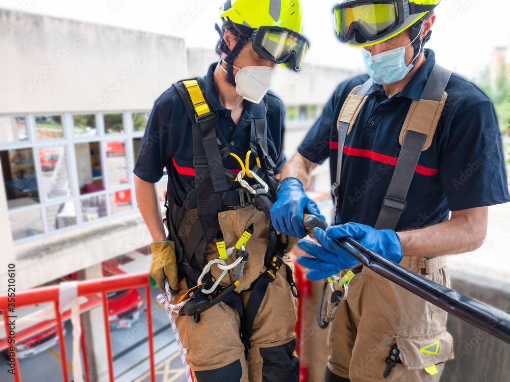 Fototapeta premium Firefighters in vertical rescue practices during a training exercise Rescue concept