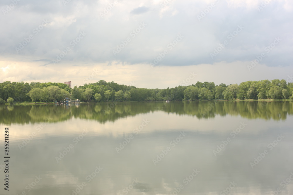 Lake in the background of the park, rainy clouds.
Lake in the background of the park, rainy clouds.