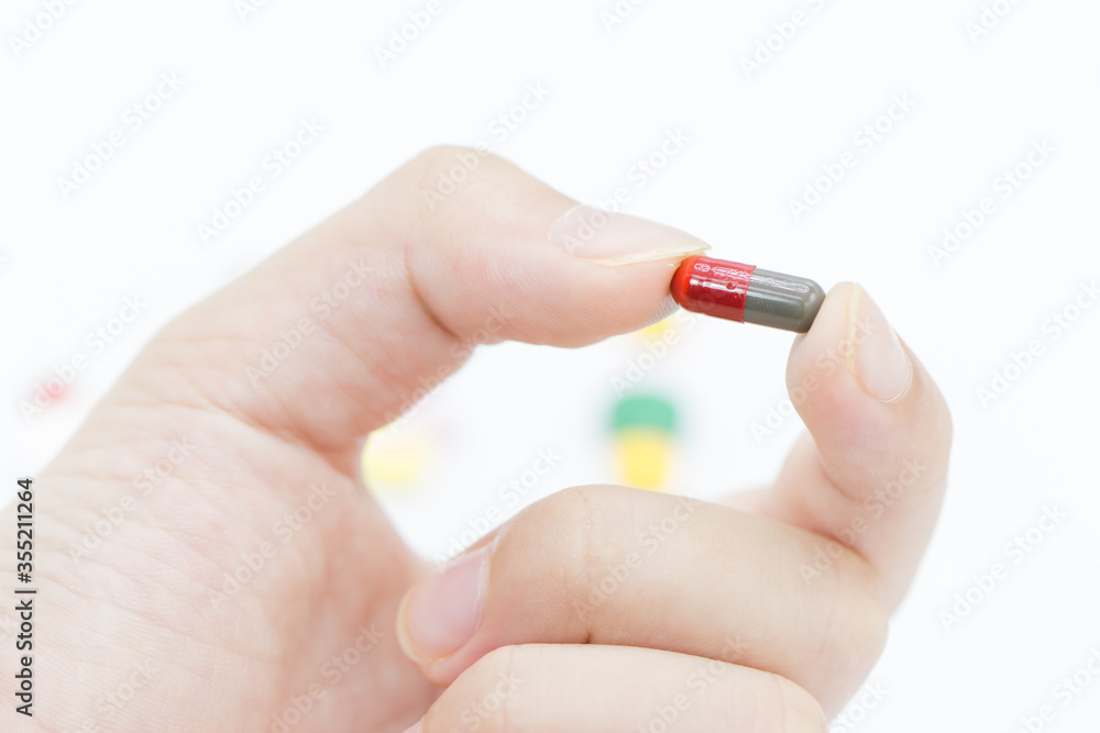Hand of man holding pill. Close up
Hand of man holding pill. Close up