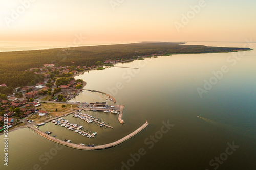 Obraz na plátně Nida city evening aerial view with yacht pier and forests in Curonian spit, Lith