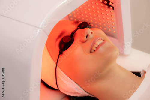 Led phototherapy for the face. LED lamp for photodynamic therapy. Face care. Light therapy at home. photo