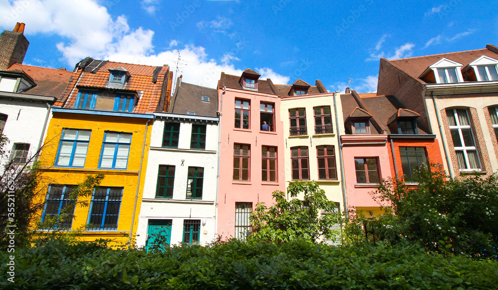 Row of old colorful houses in Place Gilleson behind Notre-Dame de la Treille Cathedral in Lille, France