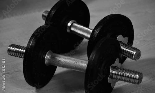 black and white photo of dumbbell weights 