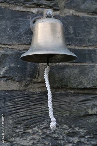 A bell on a slate wall in Wales, UK. © Wendy