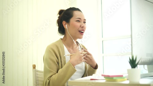 close up young asian woman studying foreign language from online course webinar (e-learning) at computer desktop inside living room for education and new normal lifestyle concept