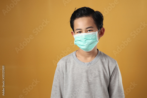 Young boy wearing mask during coronavirus covid-19 pandemic, new normal