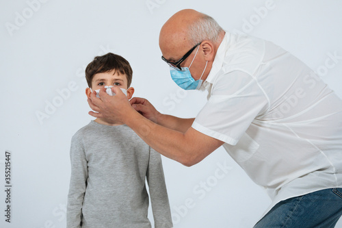  Father and son with face mask studio shoot white background