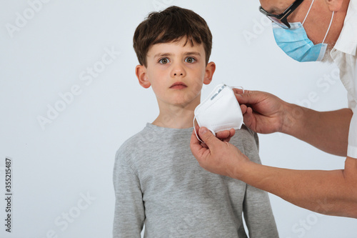  Father and son with face mask studio shoot white background