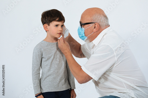  Father and son with face mask studio shoot white background