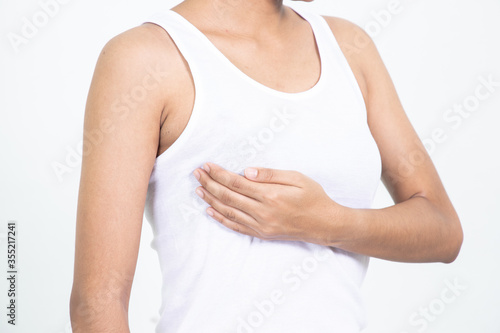 Wallpaper Mural Woman hand checking lumps on her breast for signs of breast cancer on gray background. Healthcare concept. Torontodigital.ca