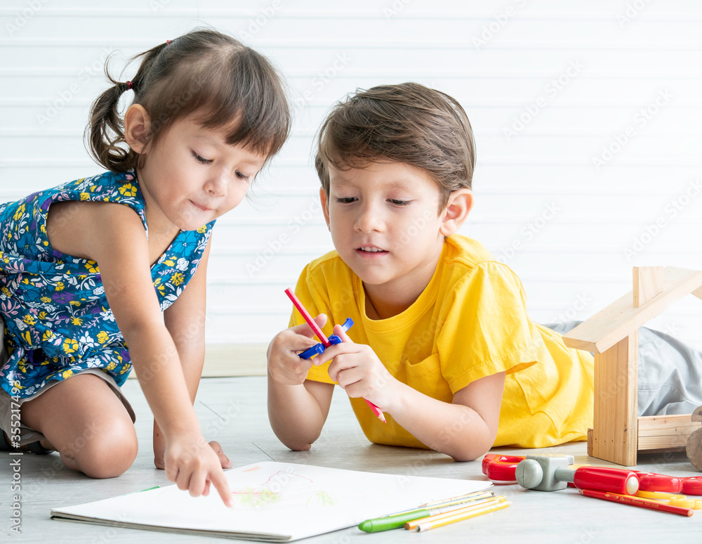 Little lovely boy and girl playing toys on the floor,Educational games for kids.Brother and Sister concept. Little lovely boy and girl playing toys on the floor,Educational games for kids.Brother and Sister concept.