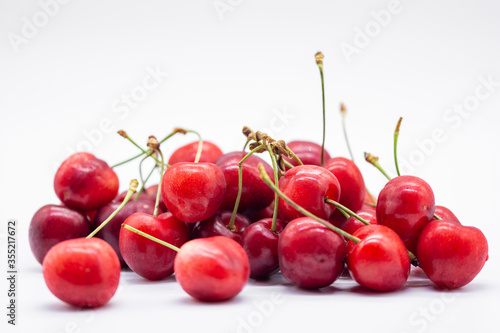 heap of ripe cherries on white background