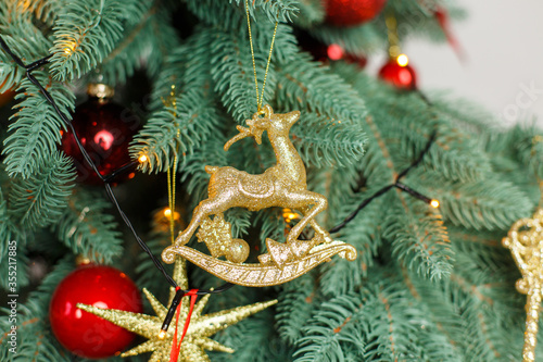 Christmas tree in red decorations. New Year composition with spruce. Classic traditional Christmas toys on a Christmas tree