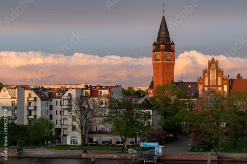 City hall clock tower aerial view of district Köpenick in Berlin, Germany with intense sky and clouds during summer sunset