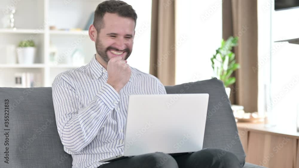 Excited Businessman Celebrating Success on Laptop at Home Excited Businessman Celebrating Success on Laptop at Home