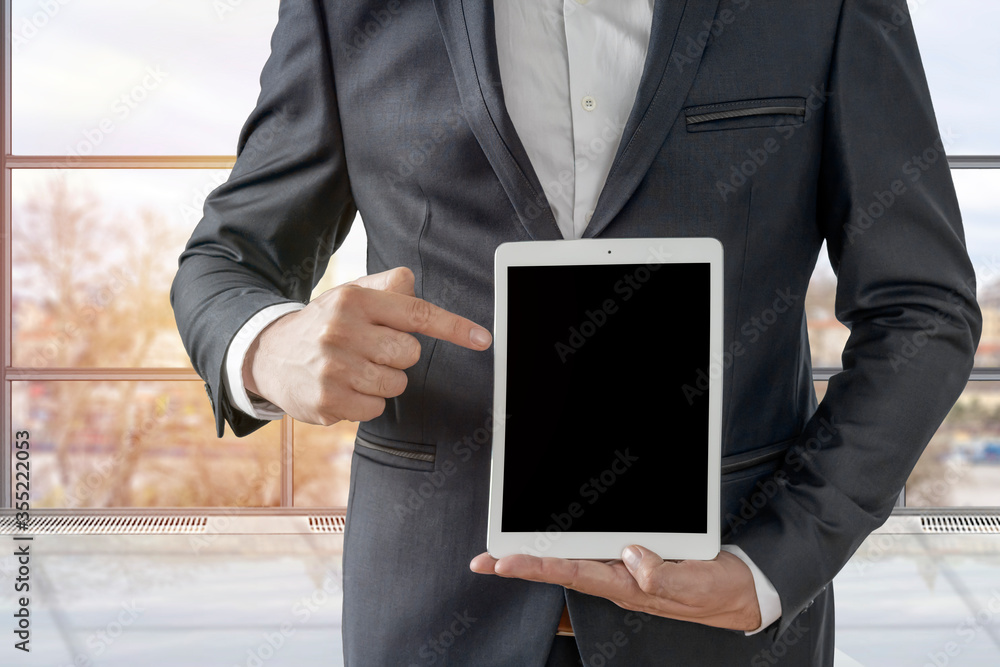 Copy space on his tablet in the office, man showing his digital tablet Copy space on his tablet in the office, man showing his digital tablet