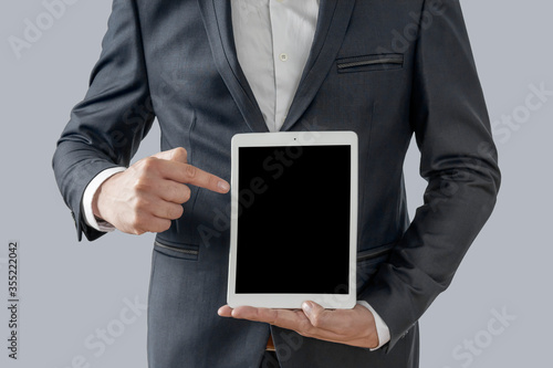 Copy space on his tablet, cropped image of man showing his digital tablet