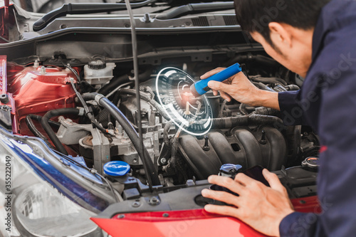 Asian Man mechanic inspection Shine a torch car engine checking bug in engine from application smartphone.Red car for service maintenance insurance with car engine.for transport automobile automotive © OATZ TO GO FACTORY