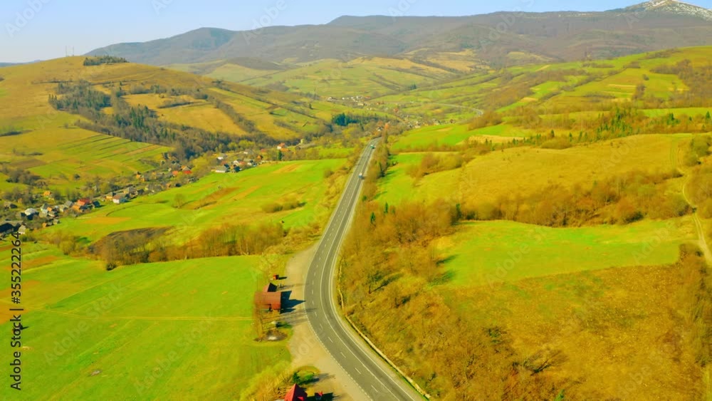 top view on road in countryside fields with green plants in spring season daytime rural scene top view on road in countryside fields with green plants in spring season daytime rural scene