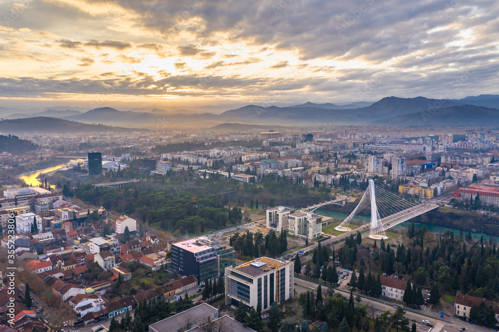Podgorica Montenegro: Beautiful sunset over the downtown including Moraca river and Millennium bridge, the famous landmark. Aerial view.