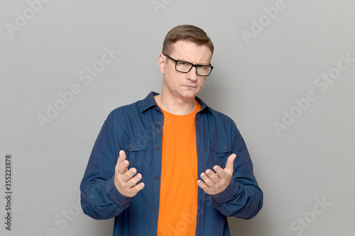 Fotografie Portrait of man stretching hands to you and expressing cordiality