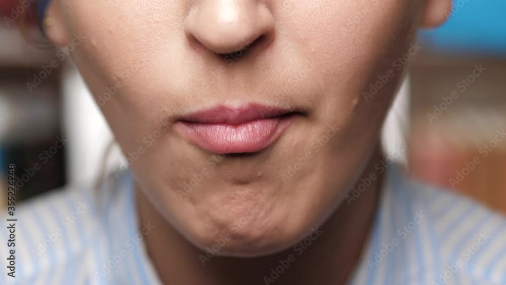 Woman is chewing. Girl moves systematically moves her jaw chewing something in her mouth Woman is chewing. Girl moves systematically moves her jaw chewing something in her mouth
