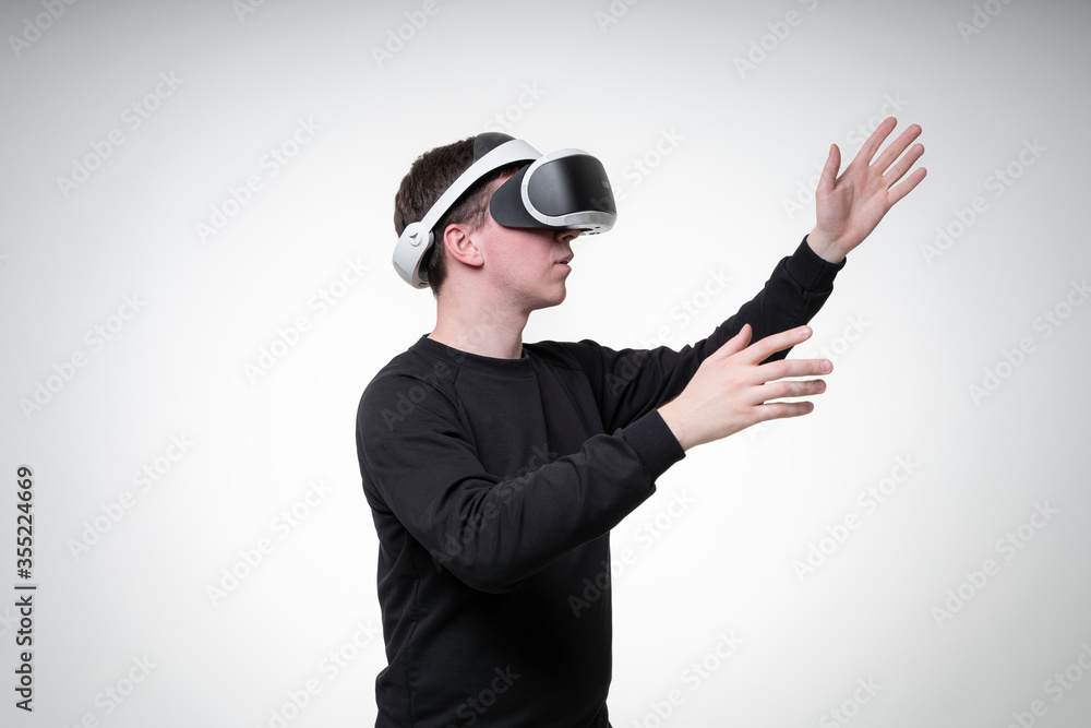 Side view portrait of a man in VR glasses, pointing up with his hand Side view portrait of a man in VR glasses, pointing up with his hand
