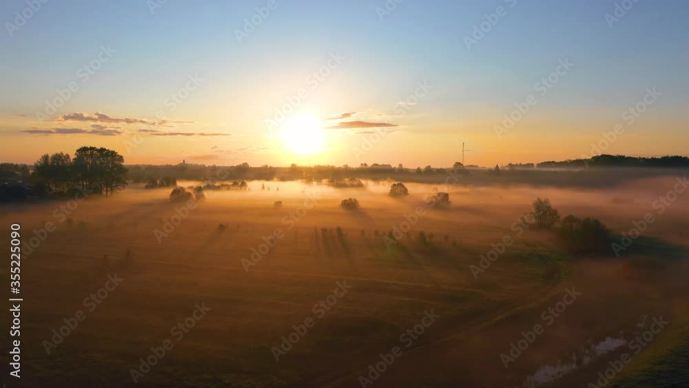 Morning fog in the meadows mouth of the river during sunrise countryside, aerial view height time lapse landscape horizon, forest village with flying birds Morning fog in the meadows mouth of the river during sunrise countryside, aerial view height time lapse landscape horizon, forest village with flying birds
